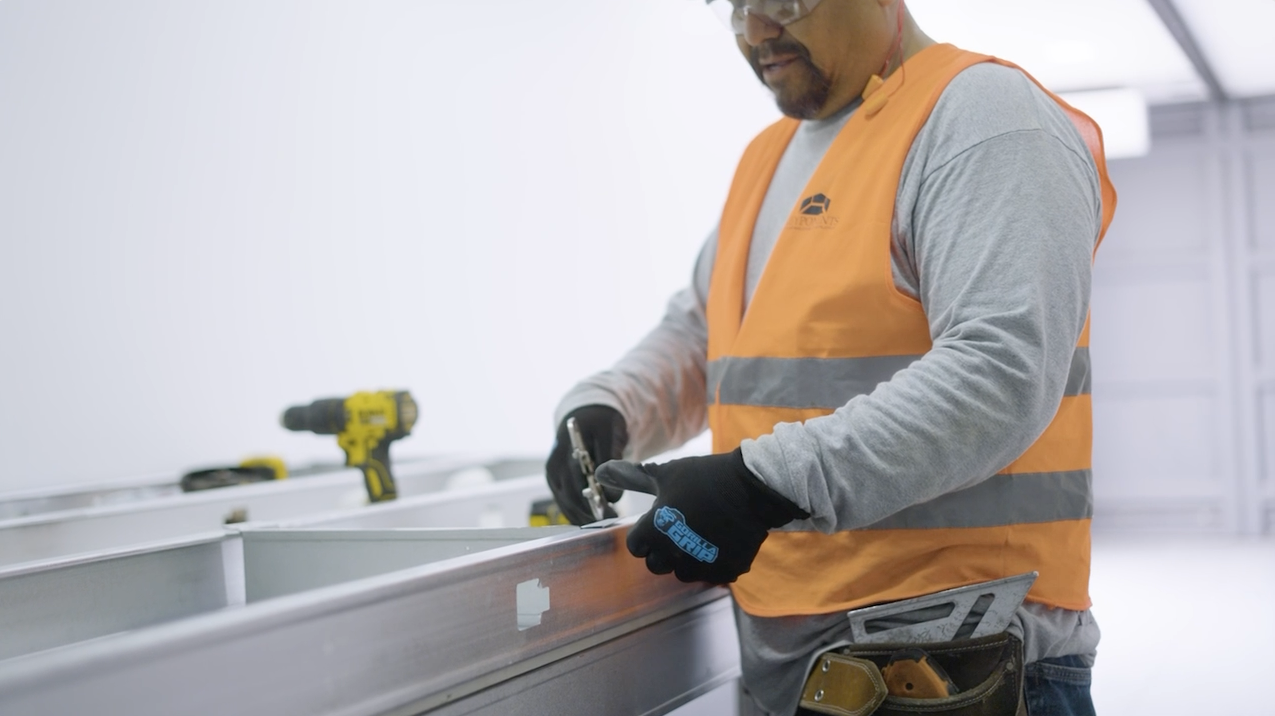 Technician fastening LGS assembly